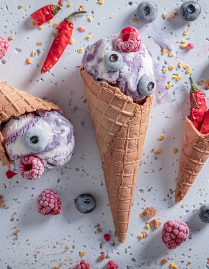 Fresh ice cream with berries and chilli. Strange icecream. New flavors of ice cream.